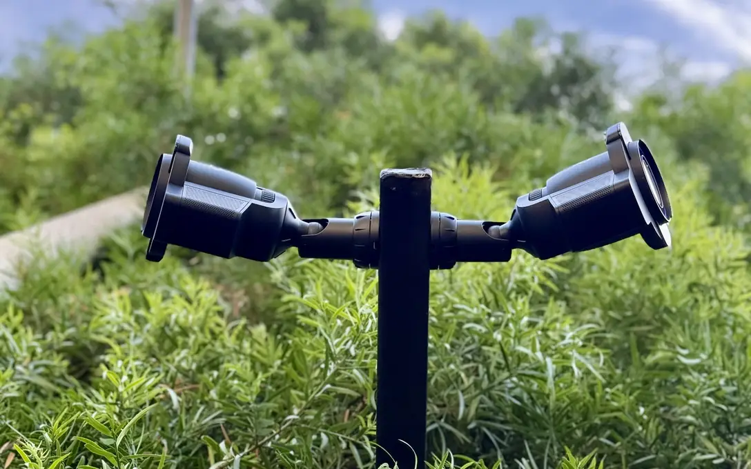 UniFi Protect bullet cameras on a black post