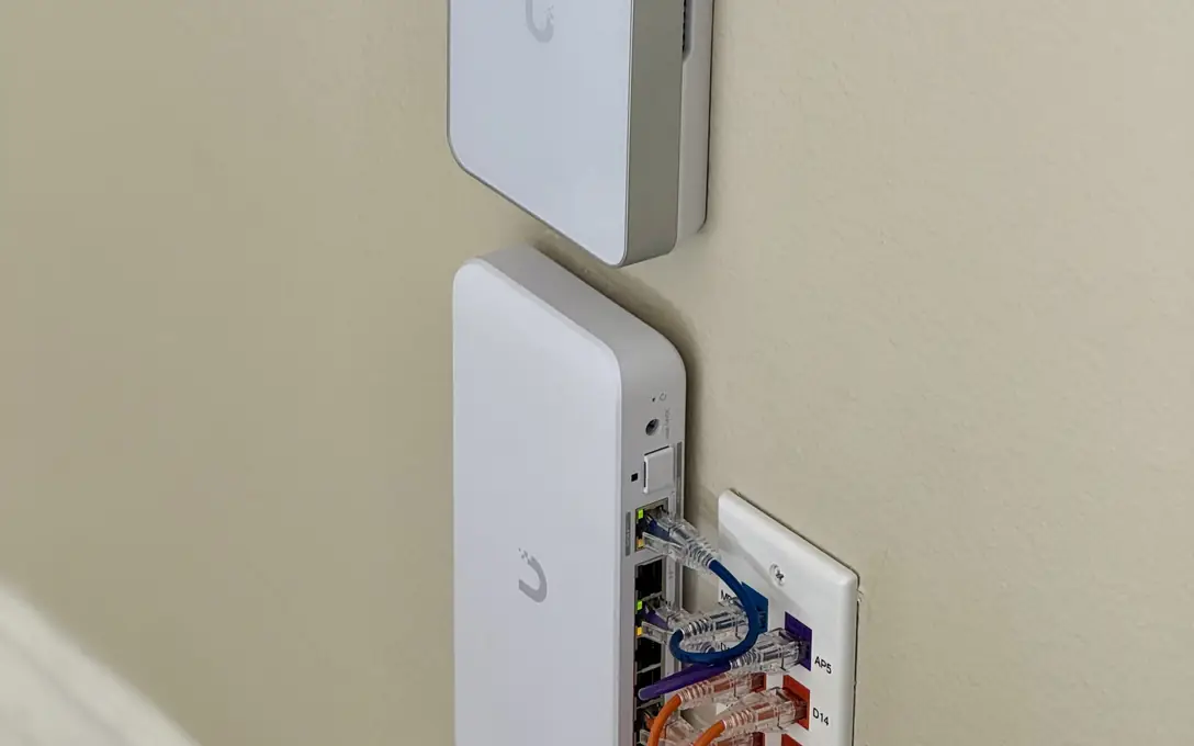 UniFi in-wall access points beside a patch plate