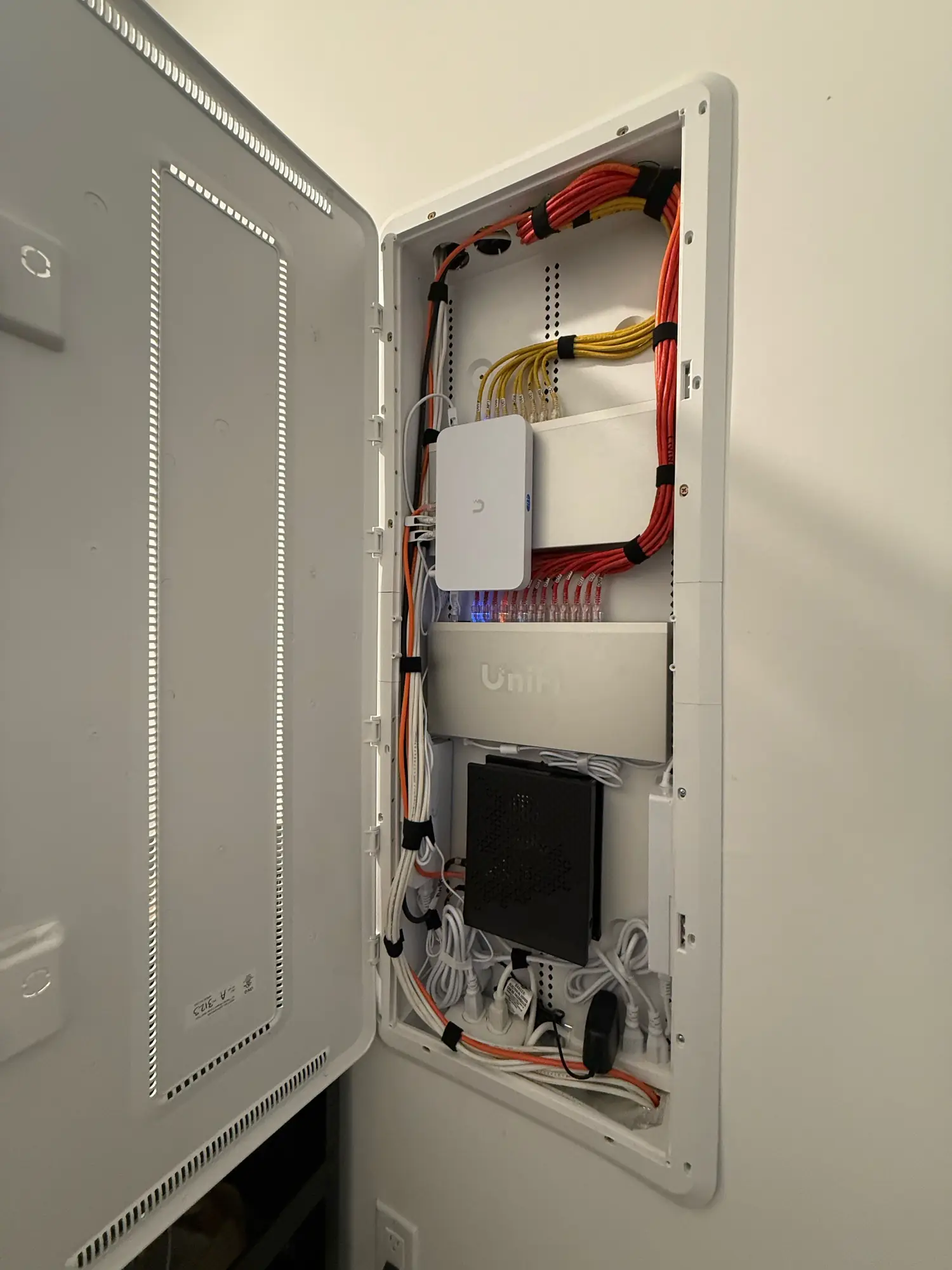 Recessed enclosure with UniFi gateway, switch and power strip