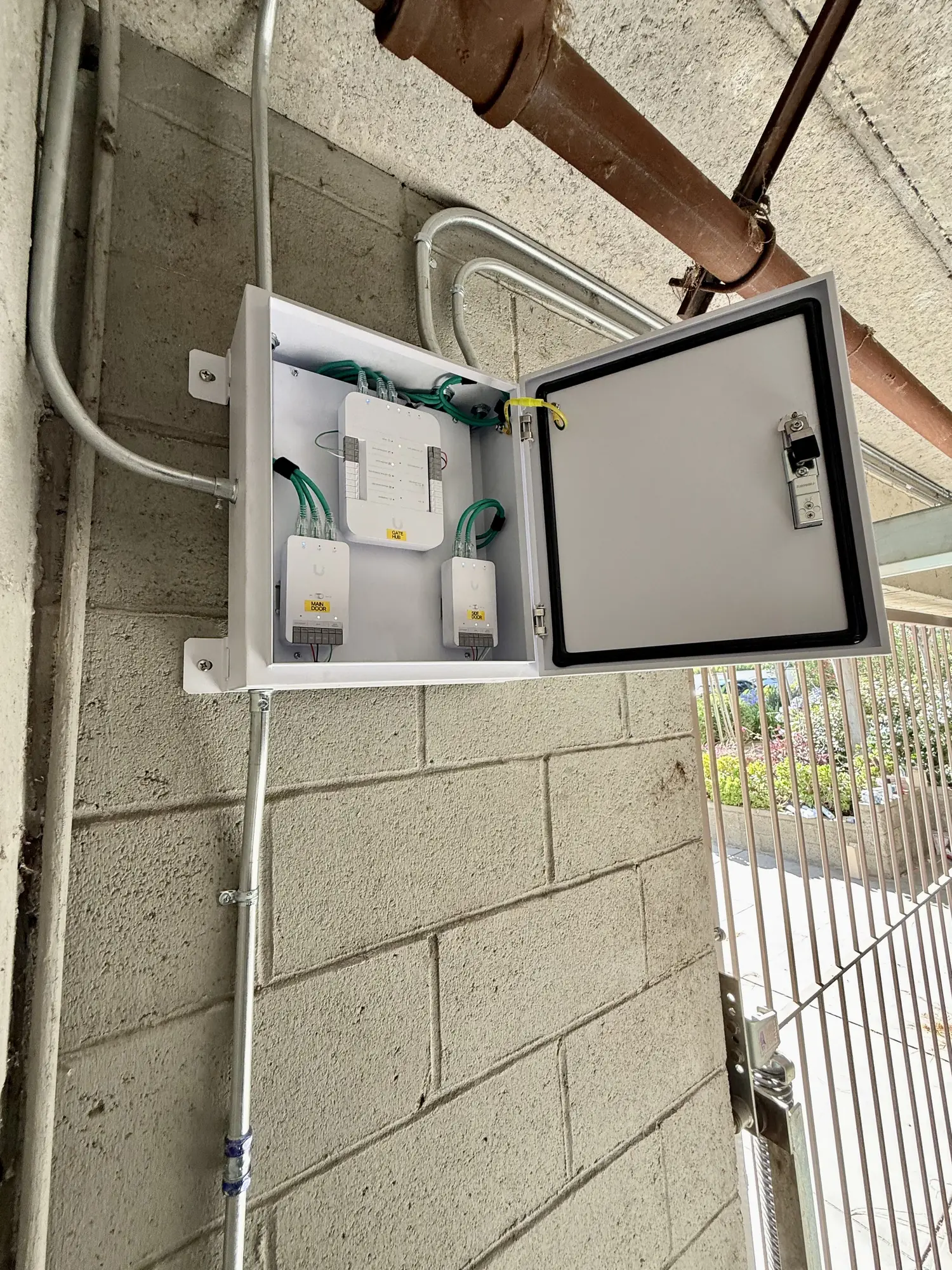 UniFi Access hubs labeled GATE HUB, MAIN DOOR and PED DOOR