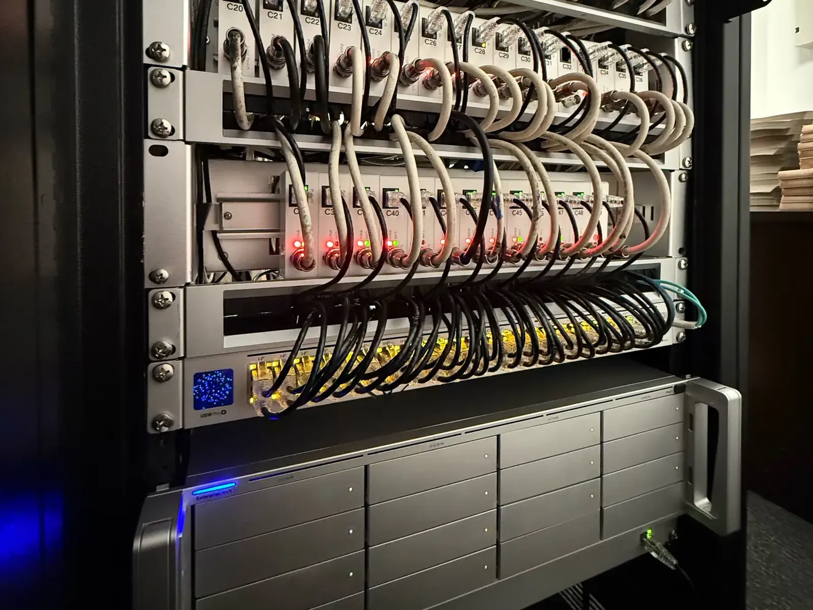Rack with labeled Long Reach extenders, UniFi switch and UNVR Pro