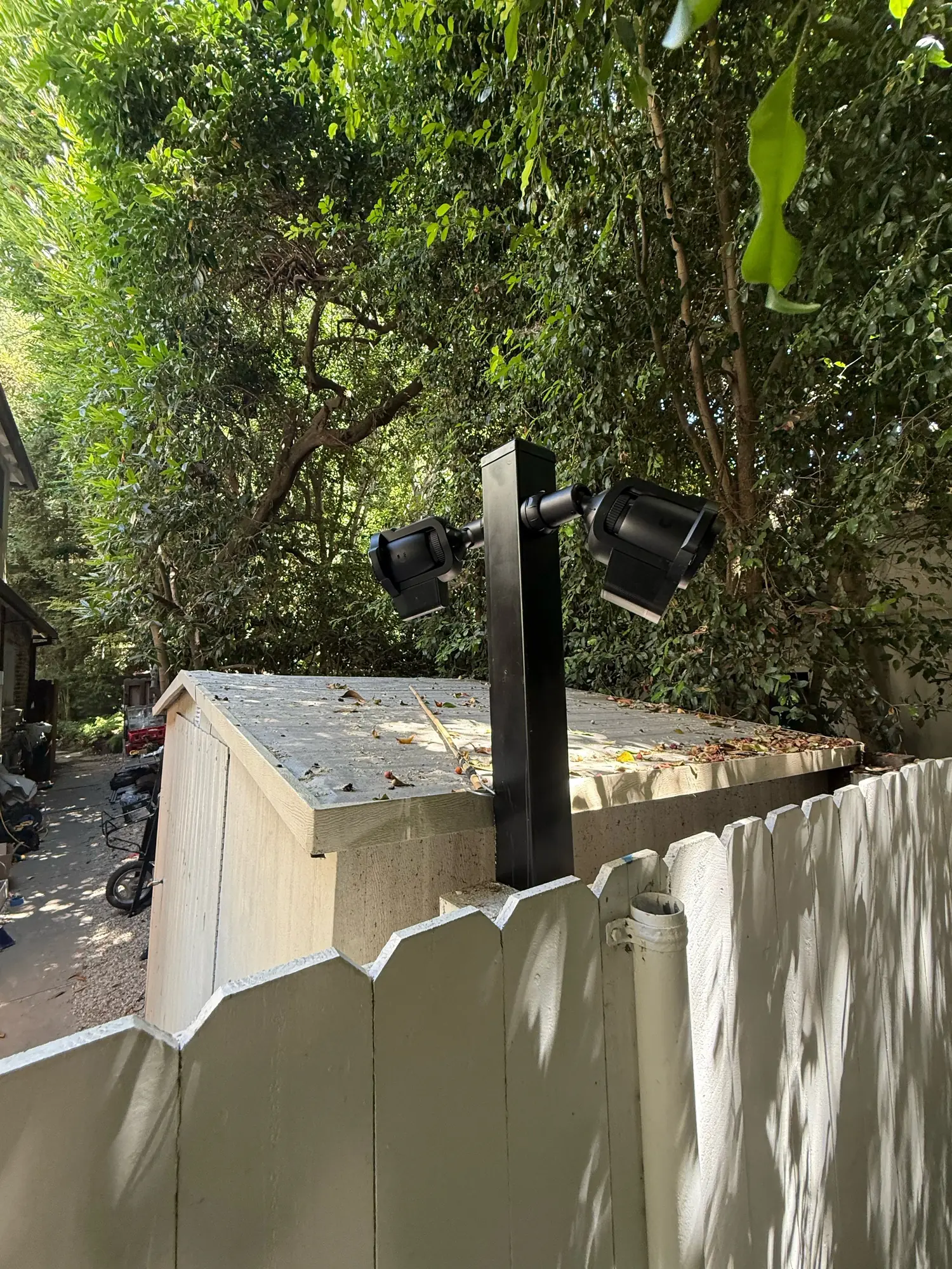 UniFi Protect cameras on a post by a fence