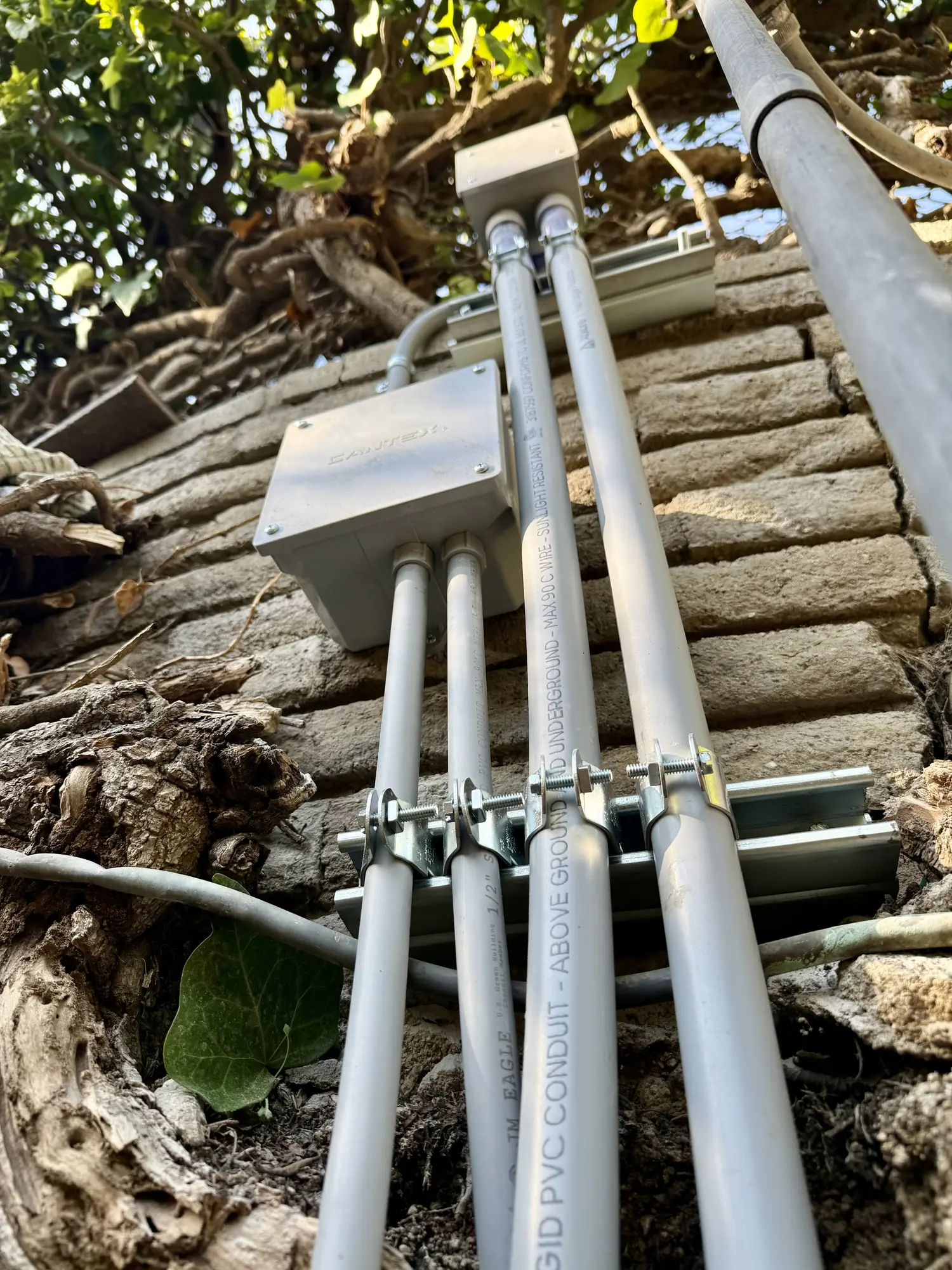 PVC conduit on a brick wall
