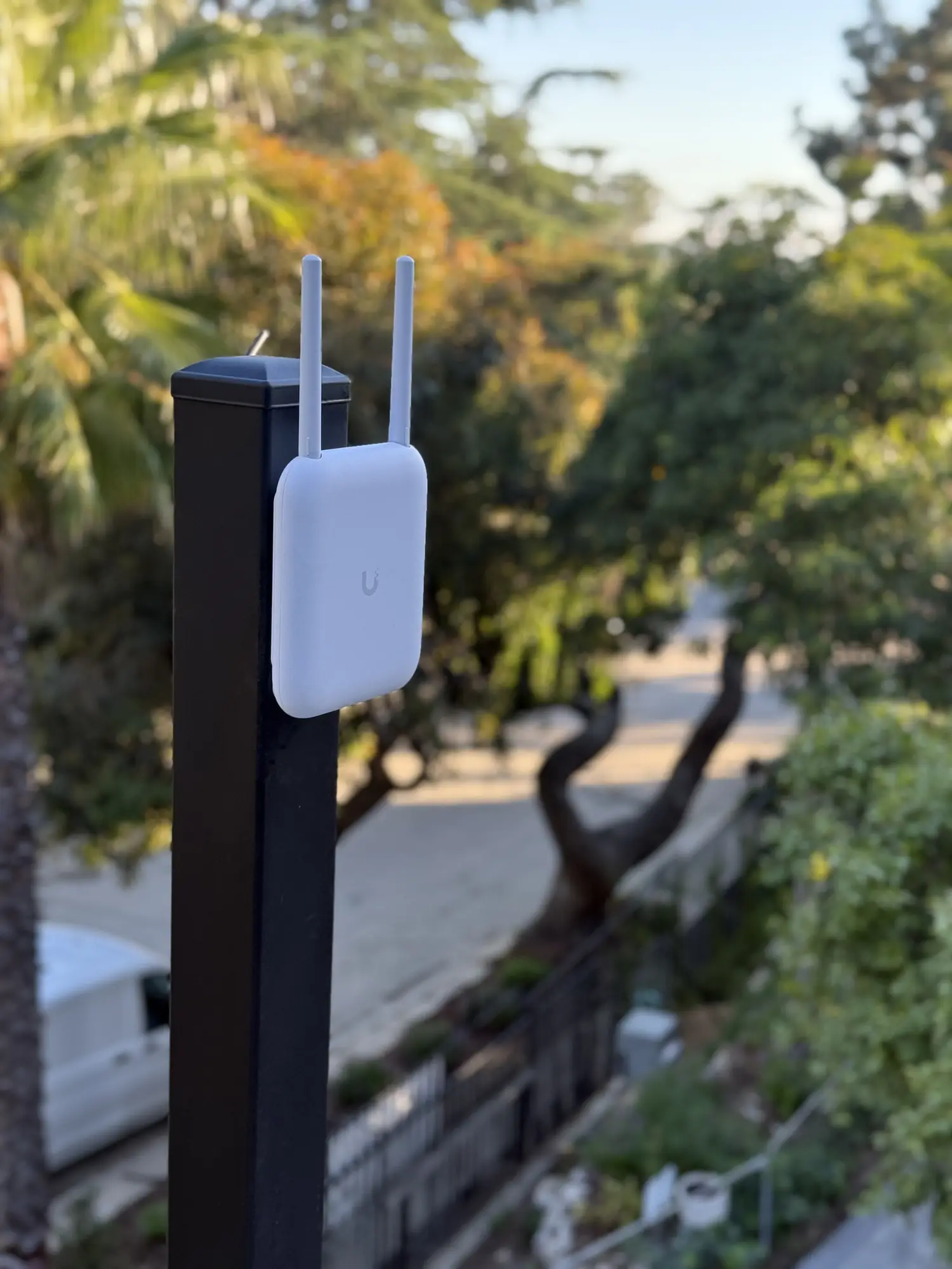 UniFi AC Mesh access point on a black post