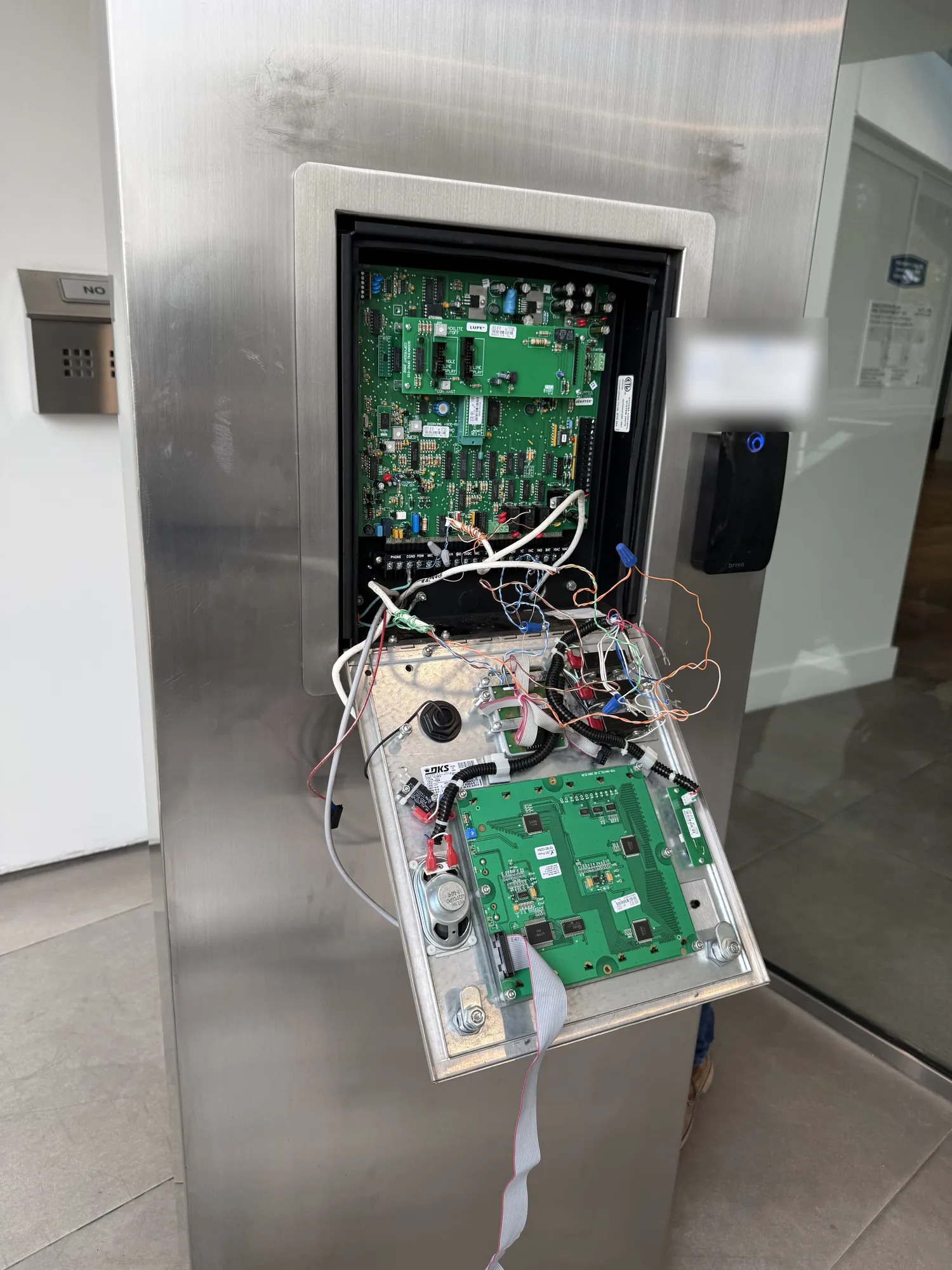 Old DoorKing unit opened, showing its circuit boards and wiring