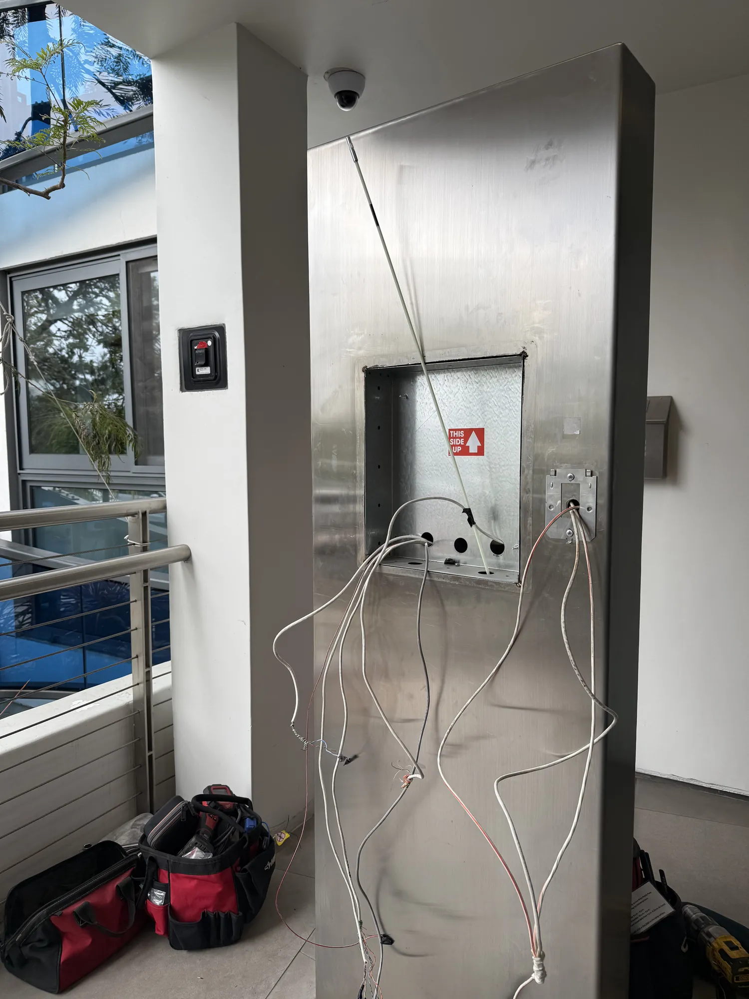 Empty pedestal cutout with cable ready for the new intercom