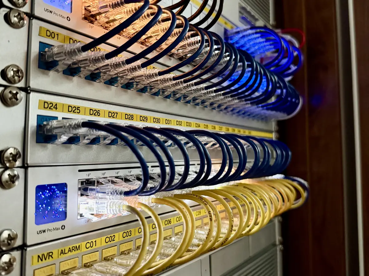 Two UniFi Pro Max switches between labeled patch panels