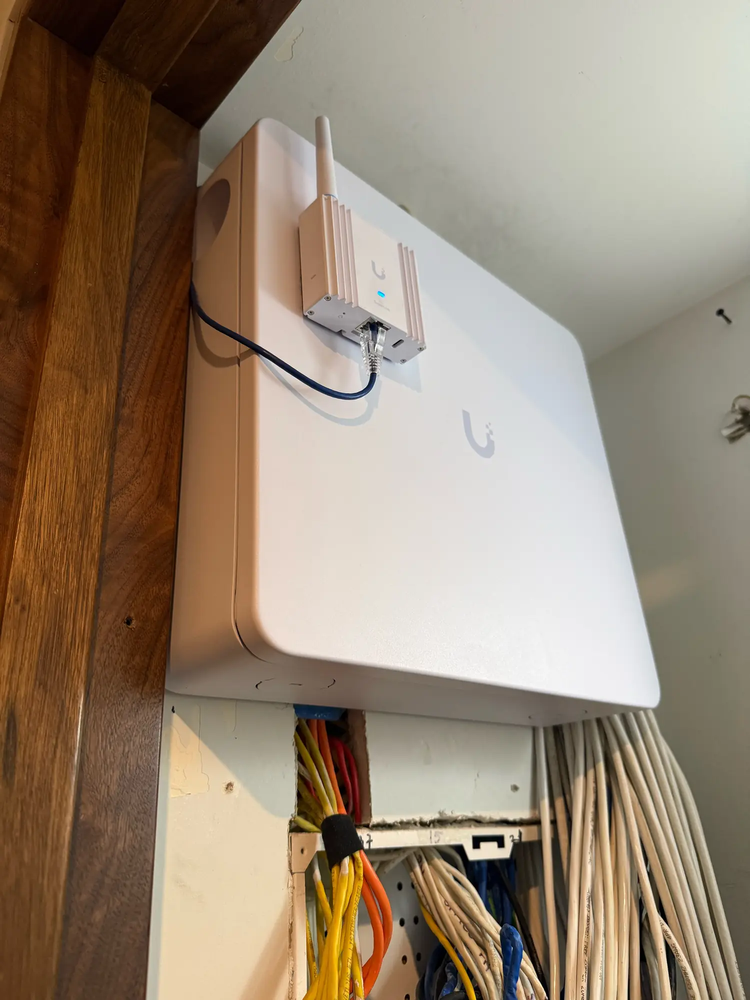 UniFi wall enclosure under the staircase, closed