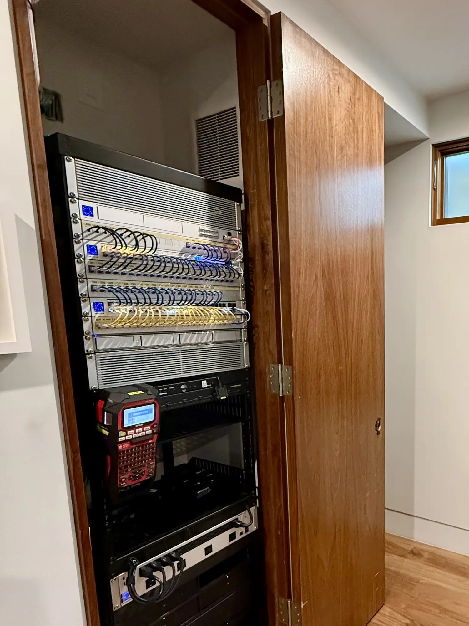 Finished rack in a closet with UniFi switches and patch panels
