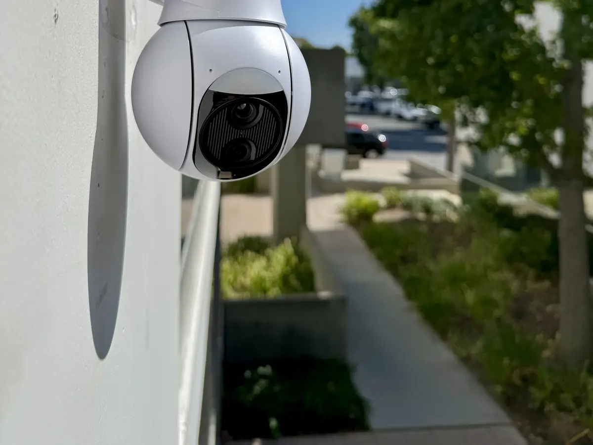 UniFi Protect PTZ camera on a stucco wall