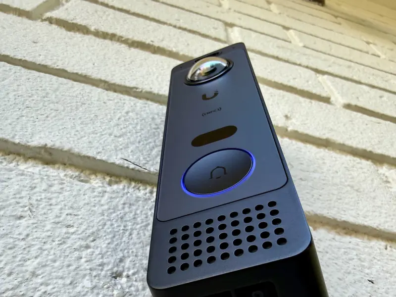 UniFi doorbell on a painted brick wall