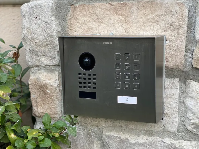 DoorBird door station and keypad on a stone wall