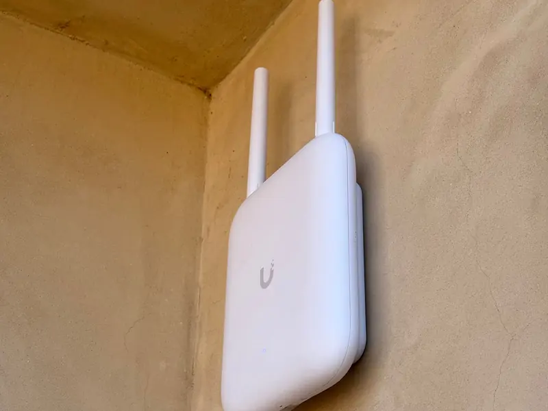 Outdoor access point on a stucco wall