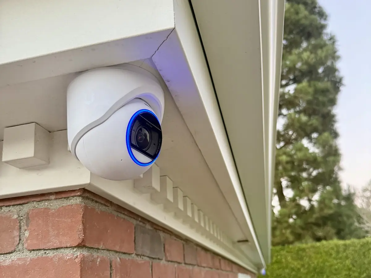 Turret camera under the eaves of a brick building
