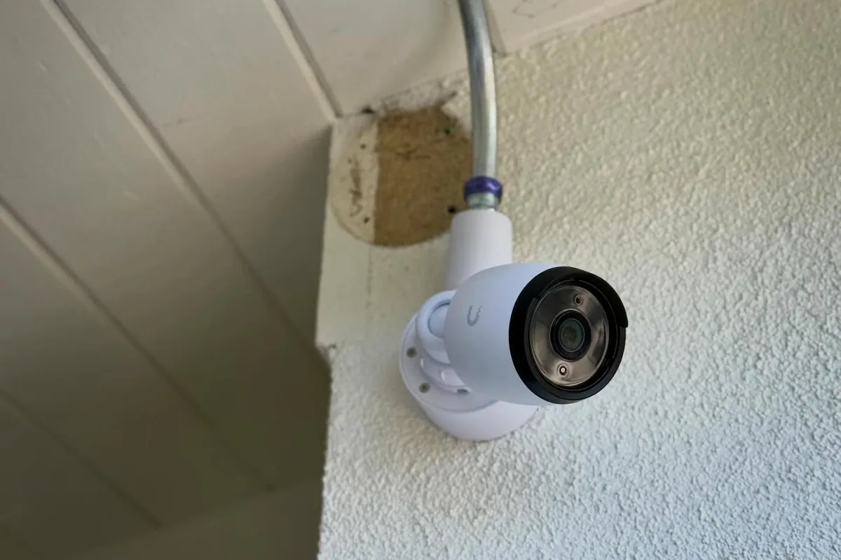 UniFi G6 Bullet camera mounted under an eave, fed through conduit