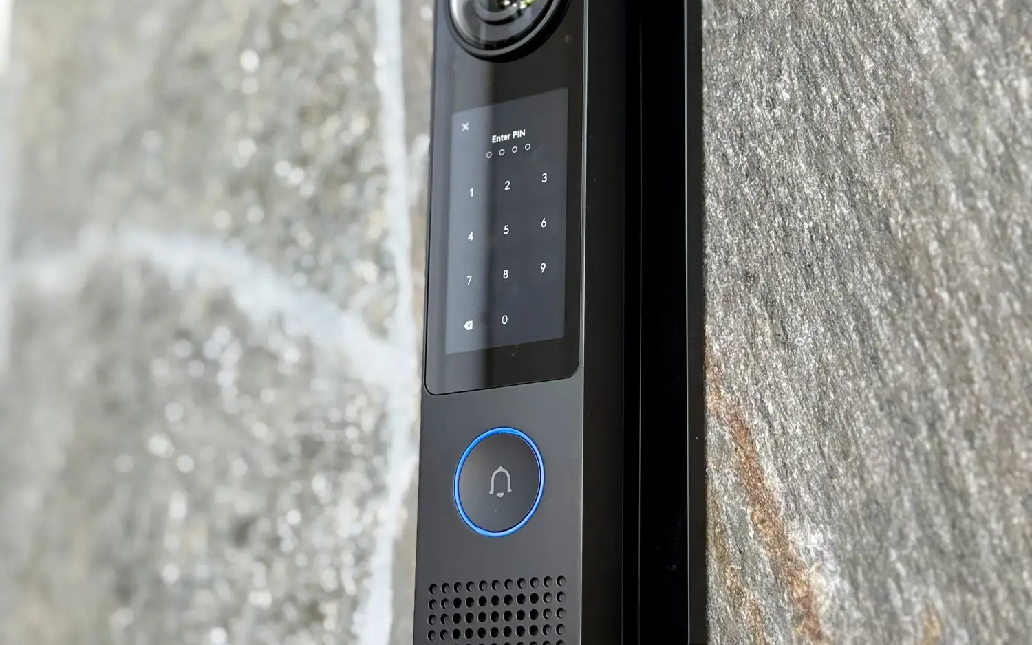UniFi Access touchscreen reader on a stone wall