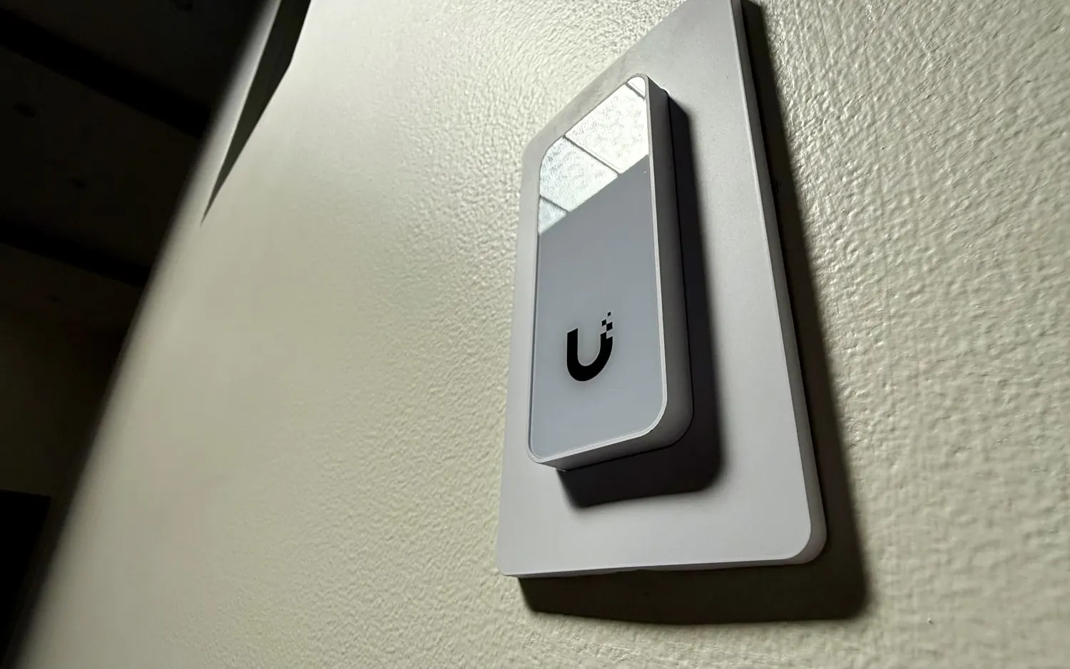 UniFi Access reader on a stucco wall