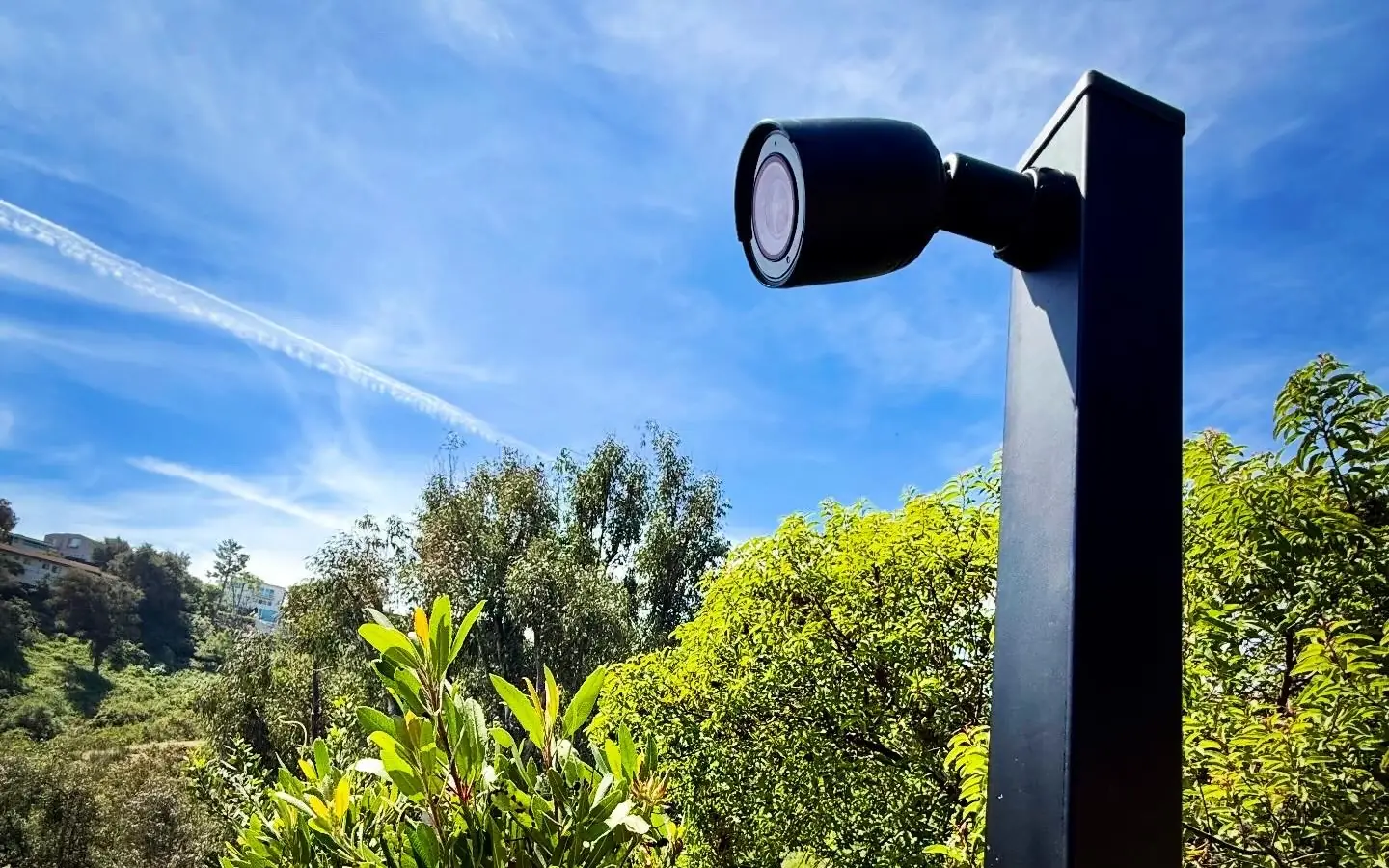 Camera on a tall black metal post on a hillside