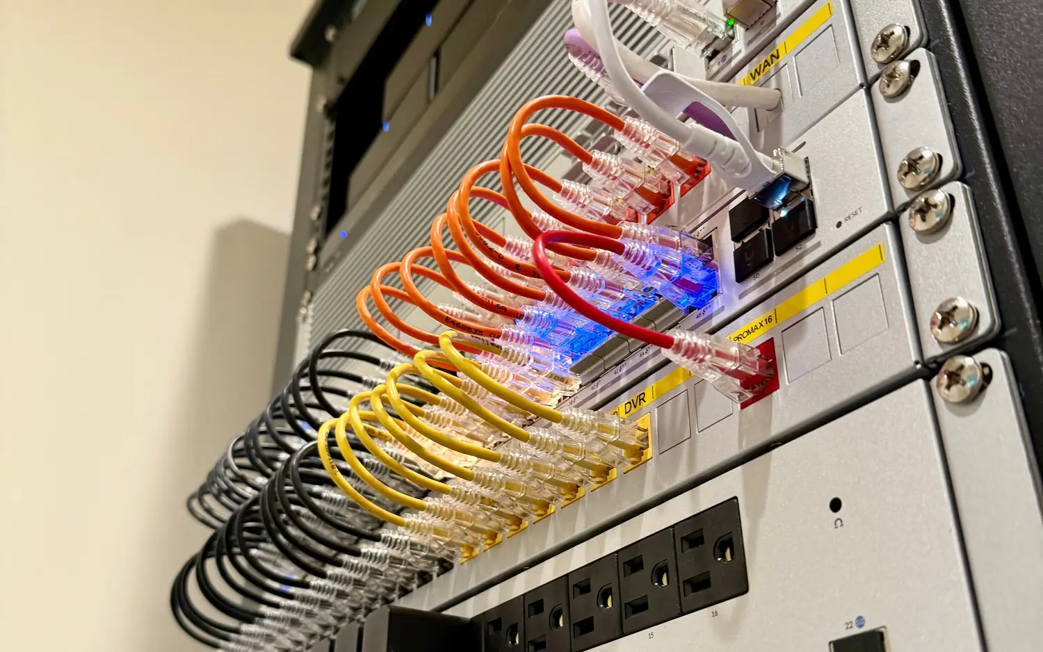 UniFi Pro Max switch with orange, yellow and white patch cables