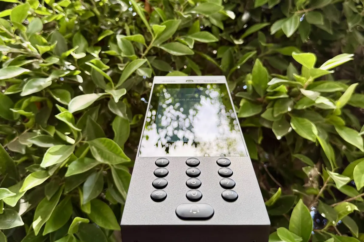 UniFi Access intercom with keypad on a pedestal in a hedge