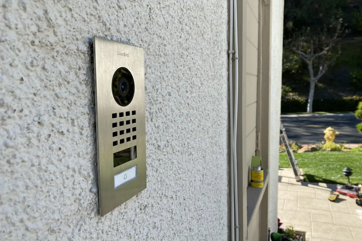 DoorBird entry panel on a stucco wall