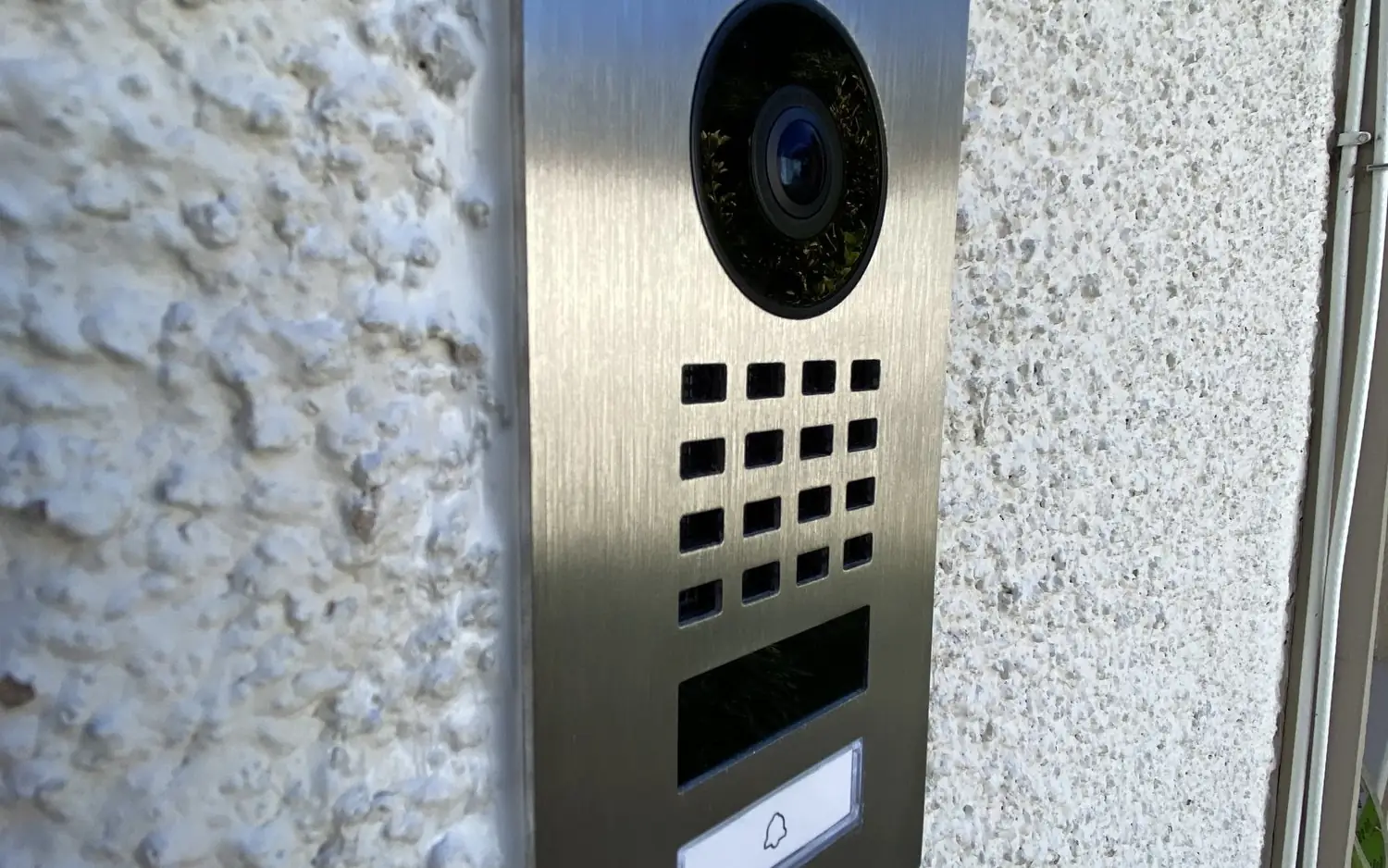 DoorBird entry panel on a white wall