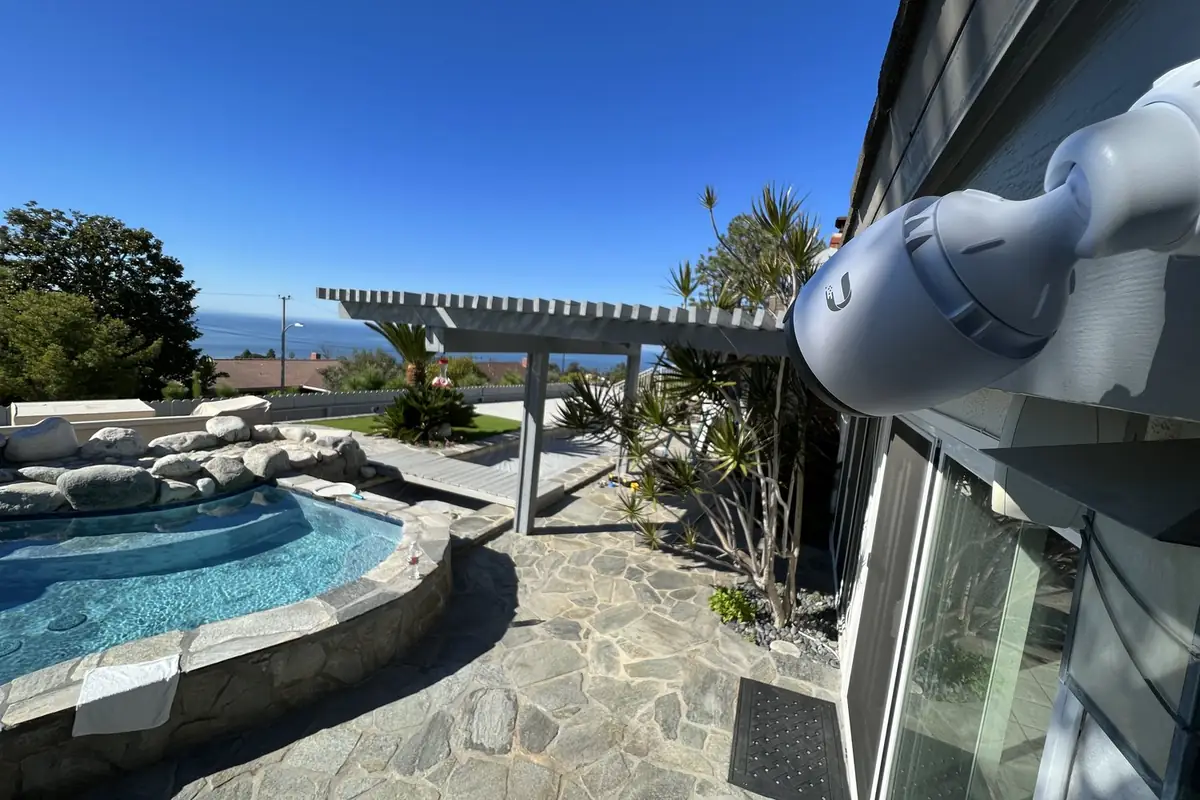 UniFi bullet camera on an eave above a patio