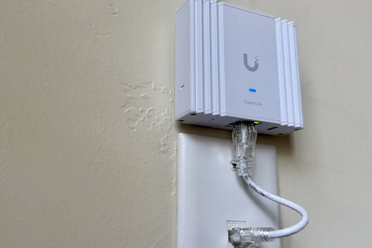 UniFi in-wall access point above a wall plate